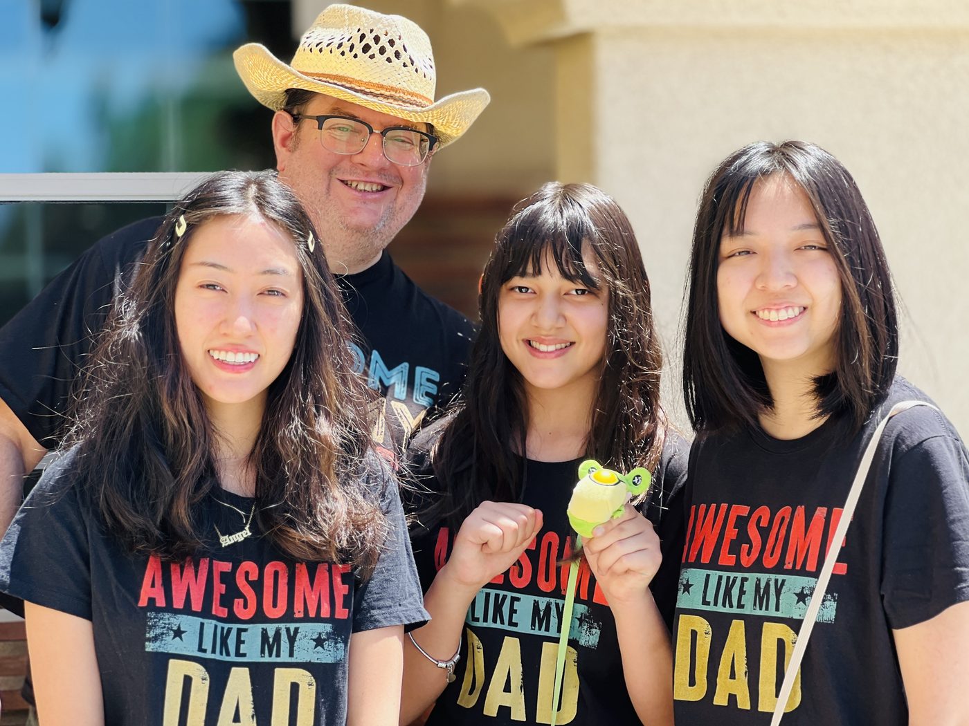T-Rex with his three daughters wearing Awesome Like My Dad shirts