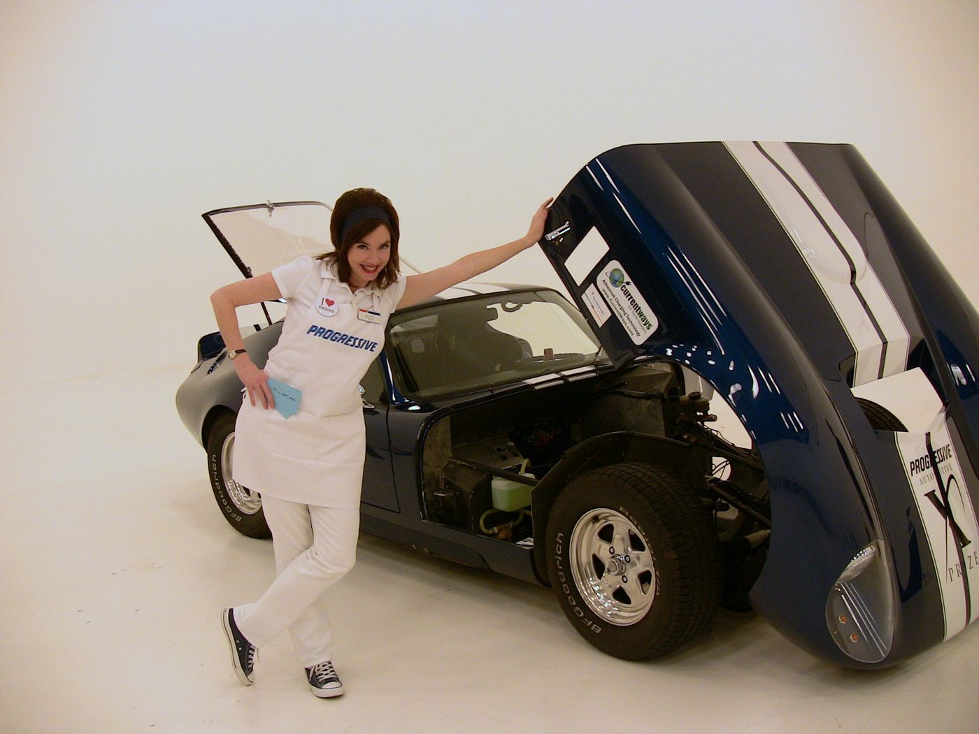 A person in a lab coat pushing the lightweight electric car by hand