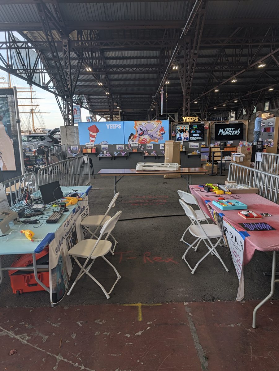 The R.O.A.R. booth tables set up under the hangar roof on Mare Island before the Faire opened
