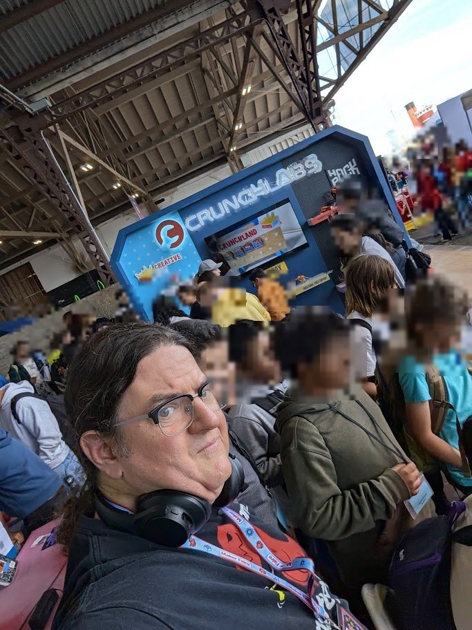 T-Rex in the crowd at Bay Area Maker Faire 2026, other visitors blurred