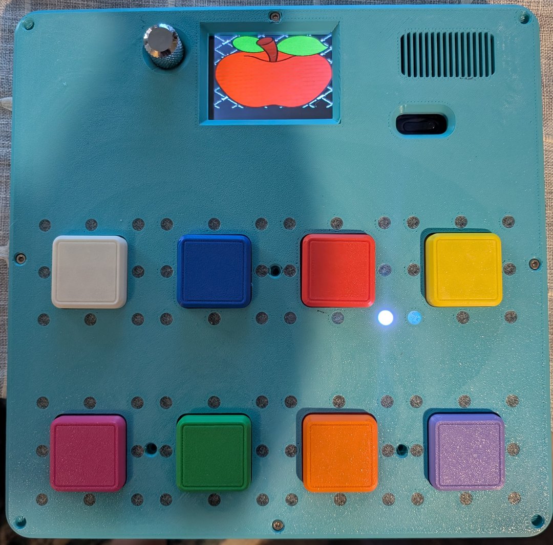 V1 Moana — teal case with 8 colored buttons and apple-on-LCD icon