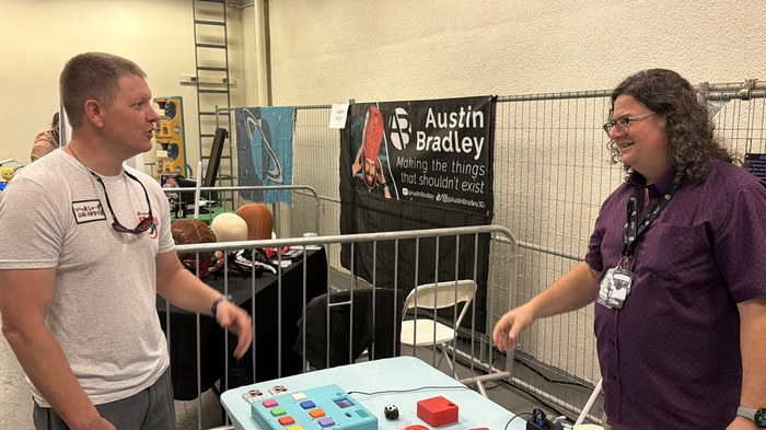 Destin Sandlin from Smarter Every Day chatting with T-Rex at the R.O.A.R. Open Sauce booth